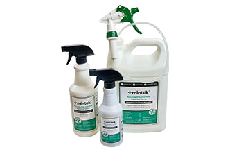 Three white disinfectant spray bottles and a large jug with green and white labels, all branded Mintek. The bottles have black or green spray nozzles and are arranged in front of a white background.